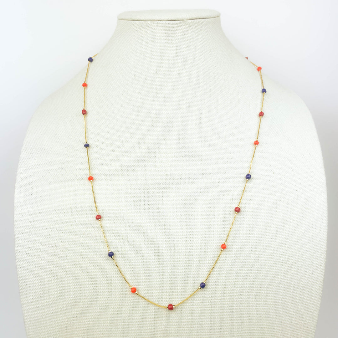 Colorful beads necklace with red, blue, and orange beads on gold chain for vibrant style