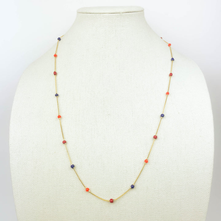 Colorful beads necklace with red, blue, and orange beads on gold chain for vibrant style