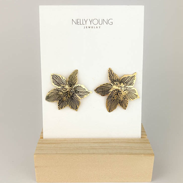 A pair of gold-plated earrings displayed on a card with 'NELLY YOUNG JEWELRY' printed at the top.