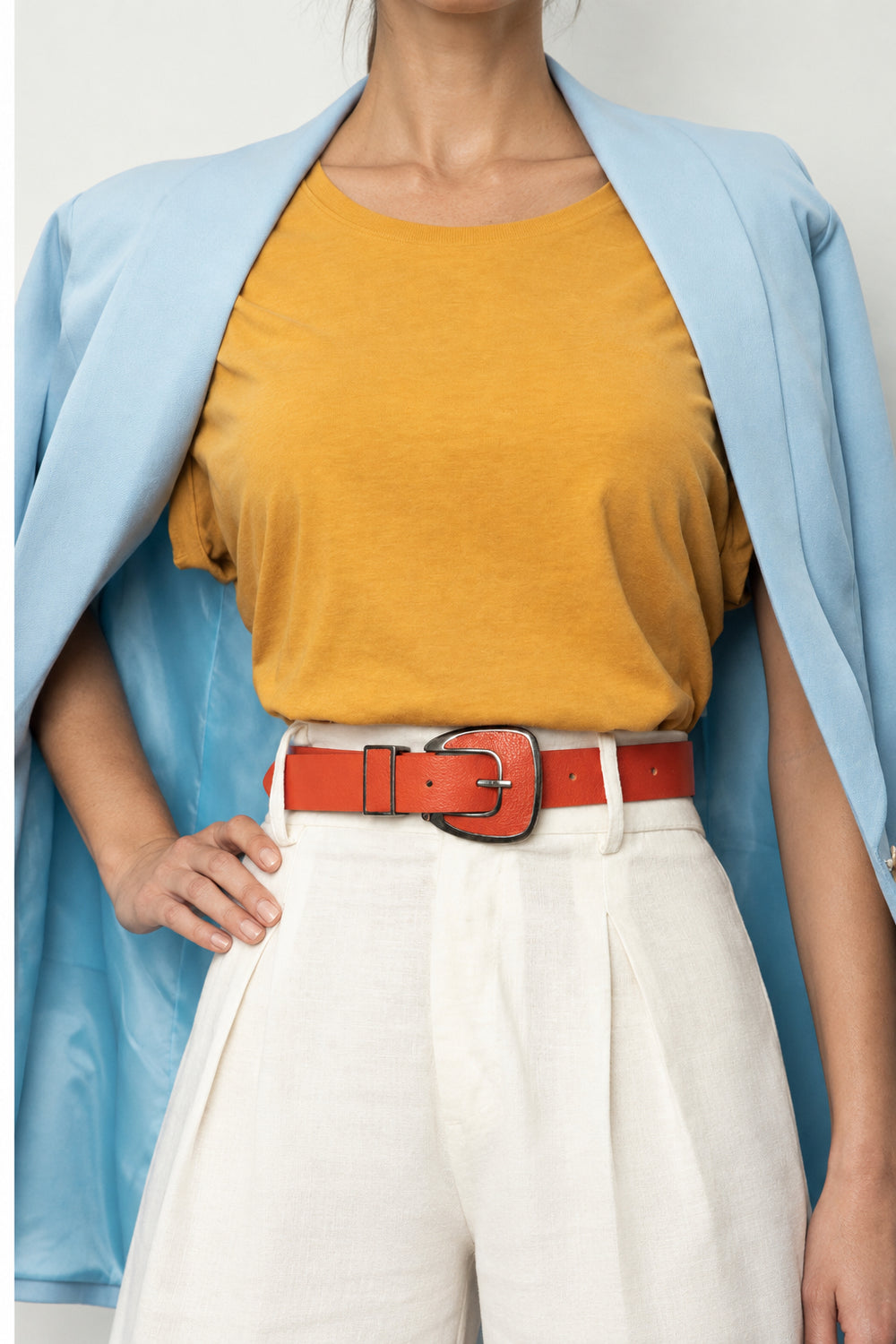 Orange leather belt with metal buckle for versatile everyday style