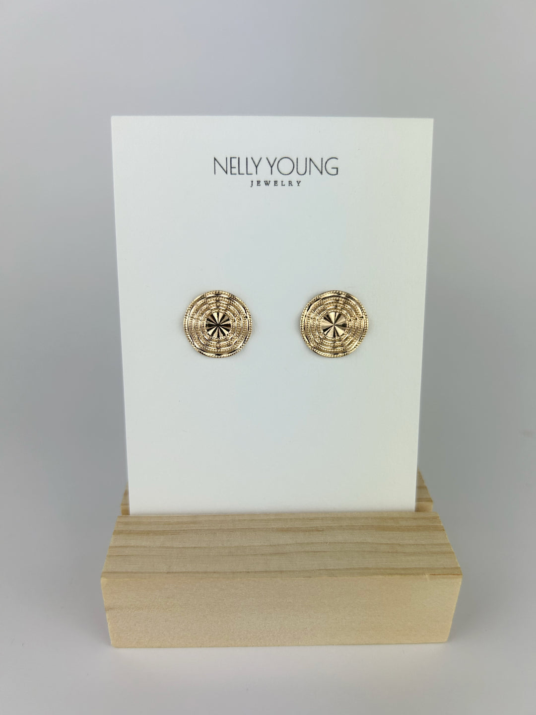 Small texture round earrings on display card by Nelly Young, featuring elegant 18K gold plating.