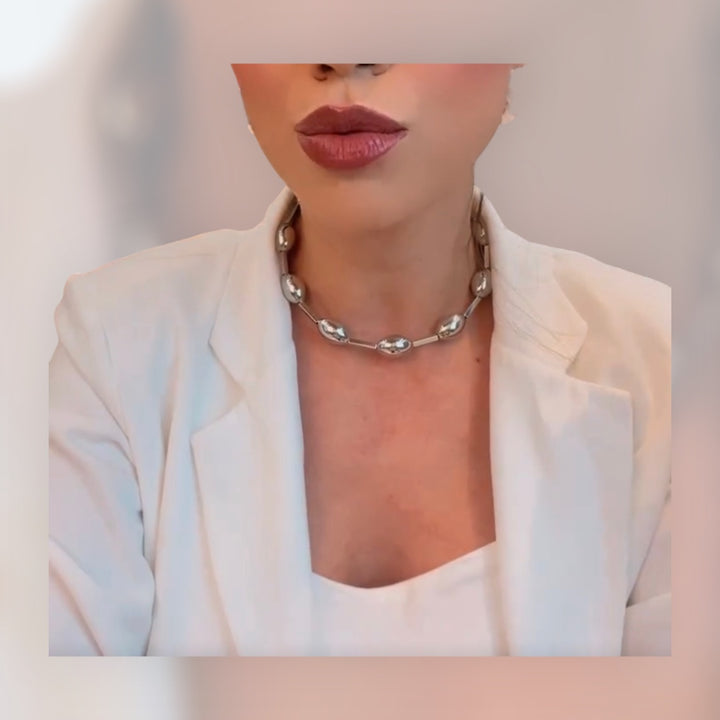 Sphere Choker gold colored spherical necklace resting elegantly on the neck