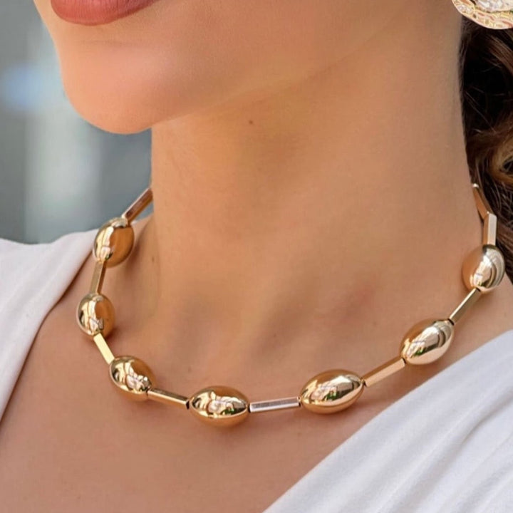 Sphere Choker gold spherical necklace with metallic clasp around neckline